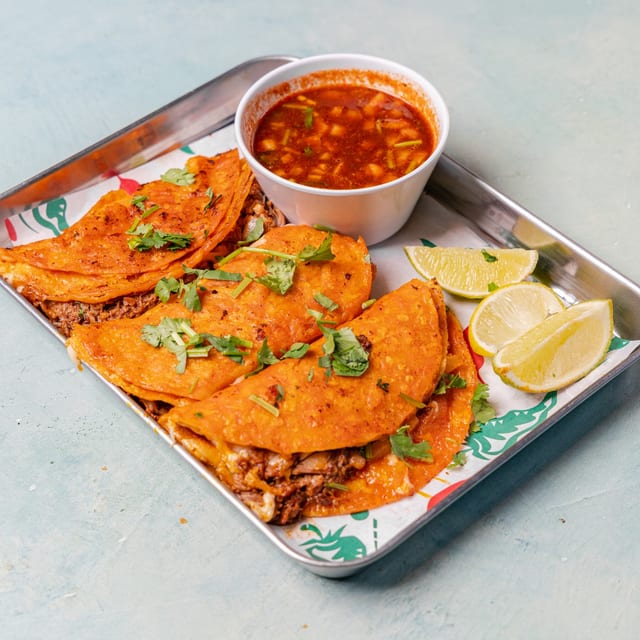 Birria Tacos with Consome (Stewed Beef Tacos with Broth).